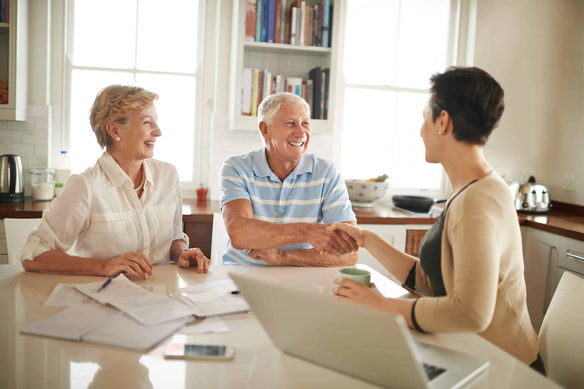 couple with a financial adviser to discuss senior rental community options