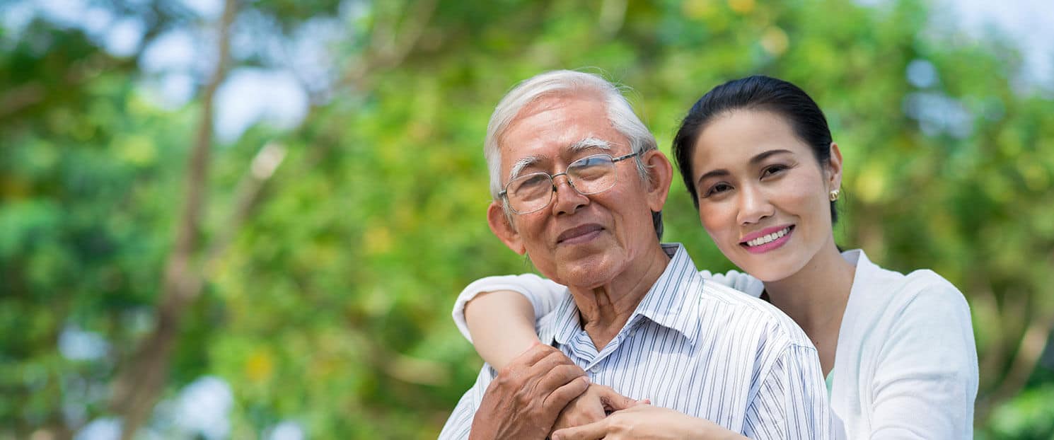 senior father and daughter smiling