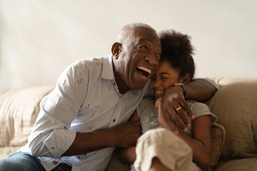 Senior man with granddaughter laughing