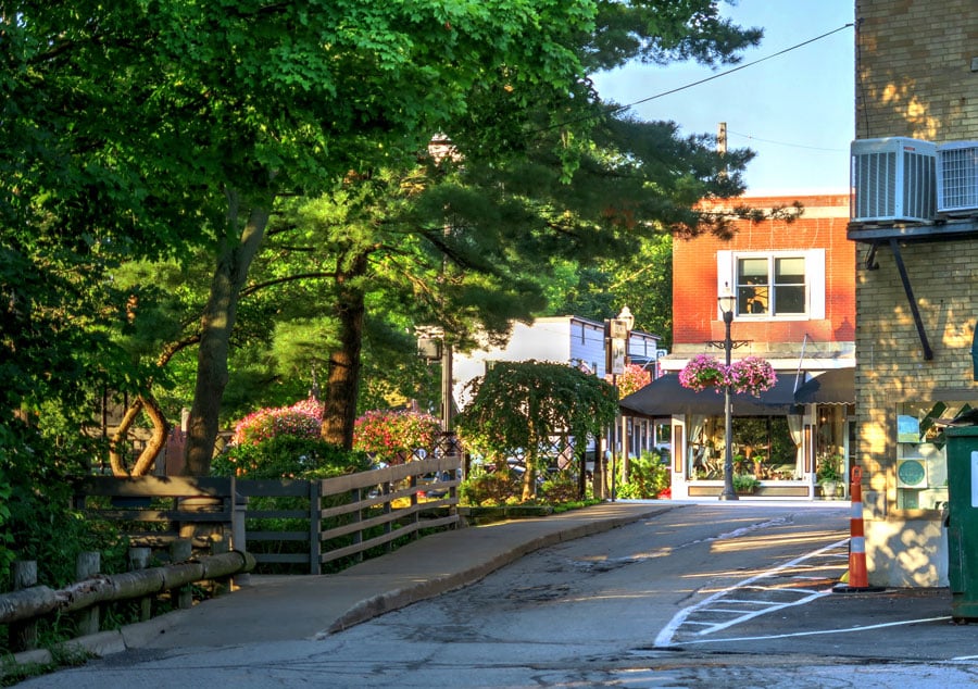 A photo of a street by the park in the downtown shopping area of Chagrin Falls