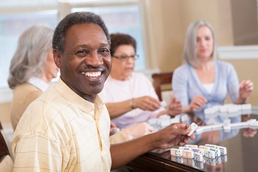 Seniors playing a game of dominoes